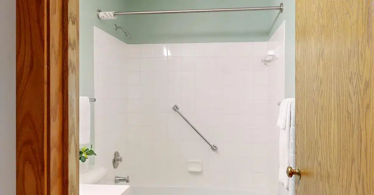 Clean and modern bathroom featuring white ceramic tiles and a bathtub.