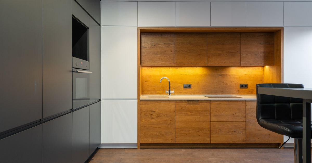 Explore a sleek and contemporary kitchen with wood accents and ample lighting.
